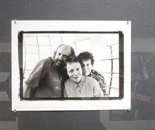 Photograph by Guido Harari of Hal Willner, Laurie Anderson and Lou Reed at the Library for the Performing Arts Lou Reed: Caught Between The Twisted Stars exhibition