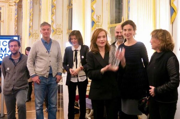 Awards season: Isabelle Huppert collects her Crystal French Cinema Award at the Ministry of Culture in Paris surrounded by directors including Benoît Jacquot and Anne Fontaine