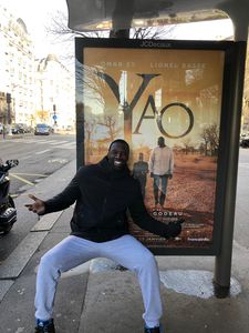 All aboard: Omar Sy beside a poster for his new film Yao at a Paris bus stop