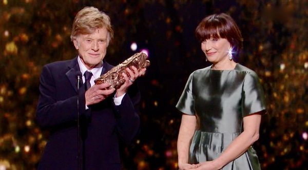 Robert Redford receives his honorary César from Kristin Scott Thomas at the César awards ceremony in Paris