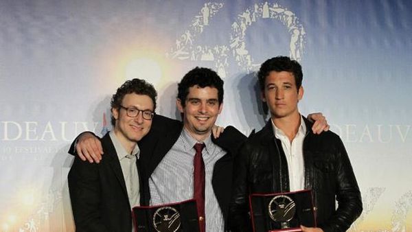 Composer Nicholas Britell, director Damien Chazelle and actor Miles Telle with the Grand Prize for Whiplash after the closing ceremony of the Deauville Festival of American Film Festival.