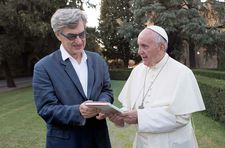 Pope Francis hands Wim Wenders a copy of his book: "It's really the Pope's humanity and the way he can bring this into words what is troubling our times."