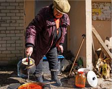 Woman making Ukrainian Borscht in Kupiansk in Slava Ukraini
