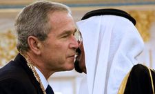 Saudi King Abdullah bin Abdul Aziz al-Saud embraces US President George W. Bush and shakes hands after presenting him with the King Abdul Aziz Order of Merit 14 January 2008 at the Riyadh Palace in the Saudi capital in Shadow World