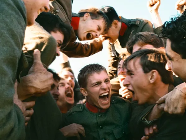 A crowd of soldiers in a huddle yelling