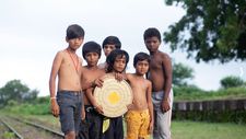 Samay (Bhavin Rabari) holding film canister with Nano (Vikas Bata), Manu (Rahul Koli), Badshah (Shoban Makwa), ST (Kishan Parmar), and Tiku (Vijay Mer)