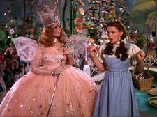 Michael Mayer on Aunt Sandy (Jennifer Coolidge) dressing as Glinda (Billie Burke) here with Dorothy (Judy Garland) in The Wizard Of Oz: “Which makes no sense, but it’s exactly what she would do. It’s just cracked enough an idea.”