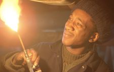Blue (Brinsley Forde) working in a garage: "It's showing life in a realistic form."