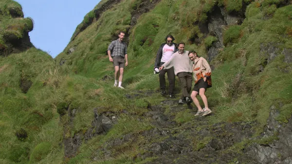 A group of blokes walking down and Irish hillside