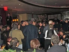 Christian Bale holding court with Sibi Blažić at Monkey Bar as Russell looks on in the foreground