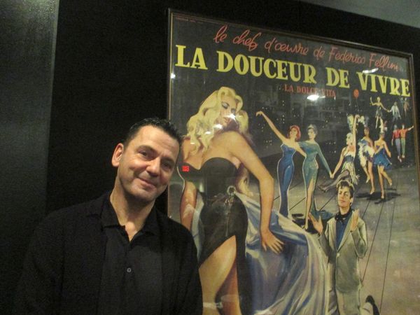 Christian Petzold in front of a La Dolce Vita poster on Hans Dieter Huesch's lullaby Abendlied, sung by Franz Rogowski in Transit: "It's something about childhood, home, relief, and death."