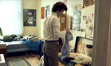 Angus Tully (Dominic Sessa) packing and My Little Chickadee poster on the wall