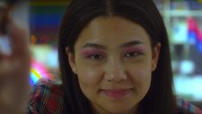 Twinkie (Sabrina Jie-A-Fa) leans forward to do Jess’ makeup.