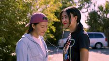 Jess (Asahi Hirano) and Twinkie (Sabrina Jie-A-Fa) share earbuds and listen to some 'sick beats' together.