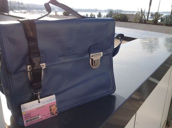 Essential part of the Cannes kit: a badge and the chic 2015 blue Festival bag.