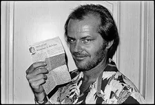 Jack Nicholson holding up Frances Taylor’s review of Mike Nichols’s The Fortune (May 1975)
