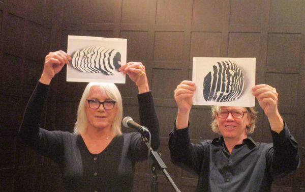Jamie Nares and Thurston Moore holding up the hastily printed-out photos of the Harry Roskolenko chopped up death mask sculpture: “I called it The Poet Is A Book.”