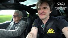 Jeremy Thomas driving to Cannes with Mark Cousins in The Storms Of Jeremy Thomas
