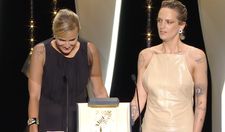 An emotional moment for Titane director Julia Ducournau, right, with actress newcomer Agathe Rousselle at the closing night of the Cannes Film Festival