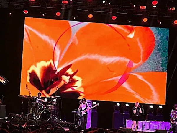 Kim Gordon singing (with Madi Vogt on drums, Camila Charlesworth on bass/electronics, and Sarah Register on guitar) at the Capital One City Parks Foundation SummerStage concert in Central Park