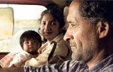 On board a lumber truck, driven by a reserved Rubén, with a mother and child as arranged passengers.