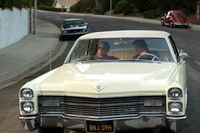 Cliff Booth (Brad Pitt) takes Rick Dalton (Leonardo DiCaprio) for a drive.