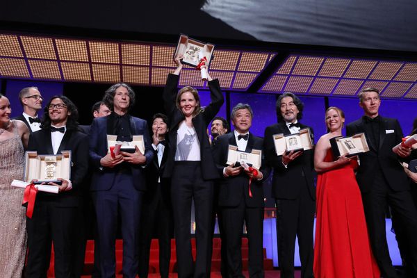 The Cannes winners line up with Palme d’Or winner Justine Triet, centre holding aloft her trophy