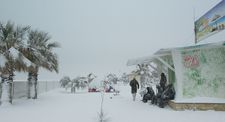 Richie Bravo (Michael Thomas) walks past refugees in the snow