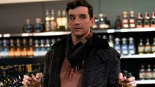 Peter (Michael Urie) purchasing the wine for the holiday celebrations