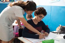 Ahmed (Idir Ben Addi) in the classroom with his teacher Mme Inès (Myriem Akheddiou)