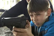 Oleg Afanasyev with Kostya's gun in The Distant Barking Of Dogs