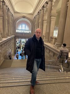 Pascal Bonitzer up the steps inside The Metropolitan Museum of Art