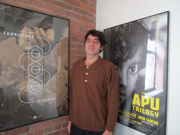 Pietro Marcello in front of an Andrei Tarkovsky Stalker and Satyajit Ray Apu Trilogy posters: “For me Martin Eden is a very contemporary character. So my objective was to span over the entire 20th century …”