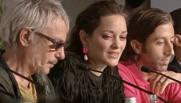 Facing the music: director Leos Carax and star Marion Cotillard and co-star Simon Helberg