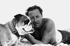 Tennessee Williams with one of his bulldogs, Tor San Lorenzo beach (Rome), 1955