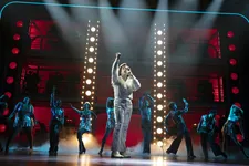 Neil Diamond (Will Swenson) performing with the singers/dancers