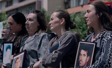 Wives holding the pictures of their missing husbands