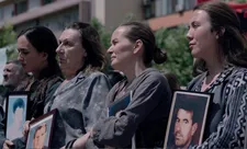 Wives holding the pictures of their missing husbands