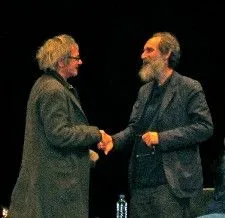 Carax and Brody shake hands