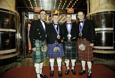 The British Olympic Curling Team showing off their medals.