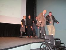 Three-term New York City Mayor Ed Koch at the age of 88 being assisted off the stage.