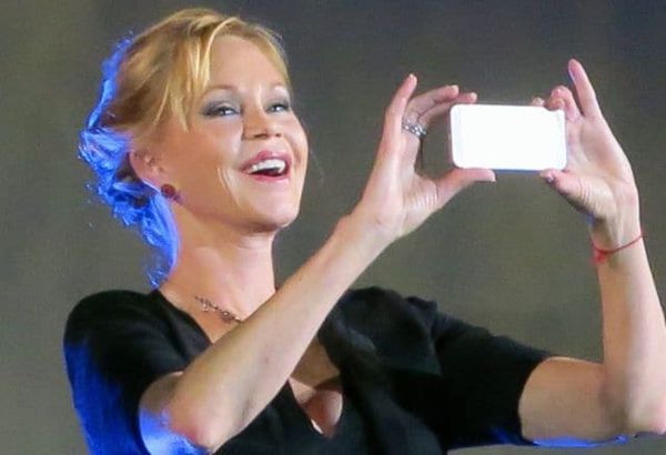 Snap happy Melanie Griffith turns her camera on the audience at the Piazza Grande in Locarno